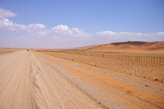 The D707 runs along the red sand dunes of the Namib