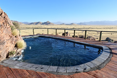 The beautifully situated pool of the camp offers a great view over the vast landscape